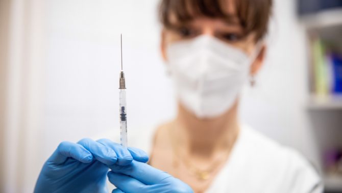 A nurse prepares a dose of Pfizer vaccine against COVID-19