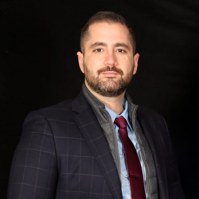 Portrait photo of Dr Aggelos Kaskanis in black background